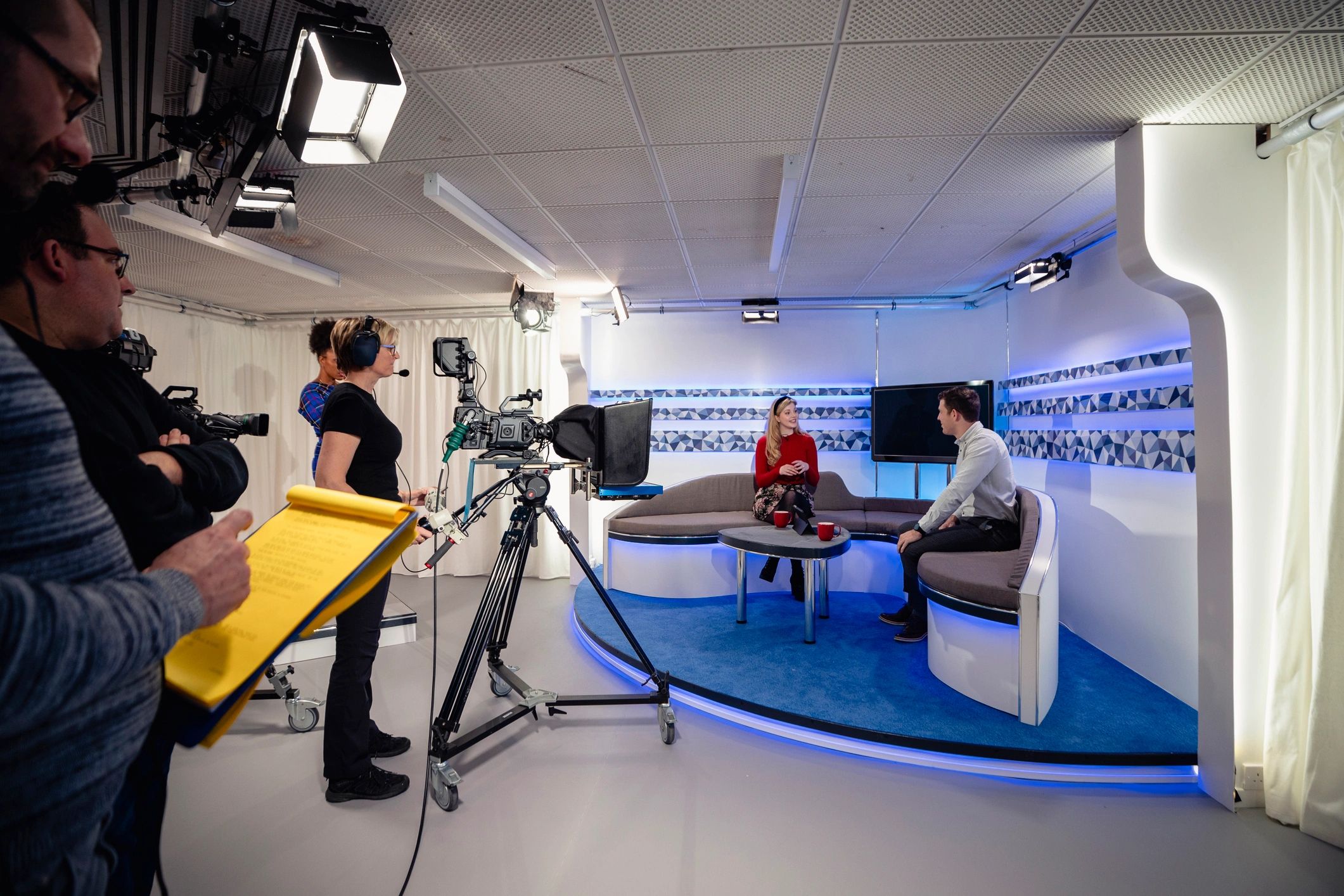 Studio interview being filmed with presenters on set